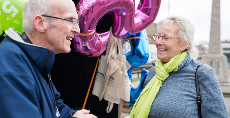 Elderly man and woman talking together at a Healthwatch event Elderly man and woman talking together at a Healthwatch event