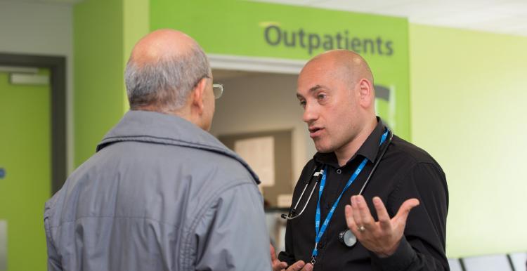 Doctor speaking to a patient in an outpatient clinic Doctor speaking to a patient in an outpatient clinic